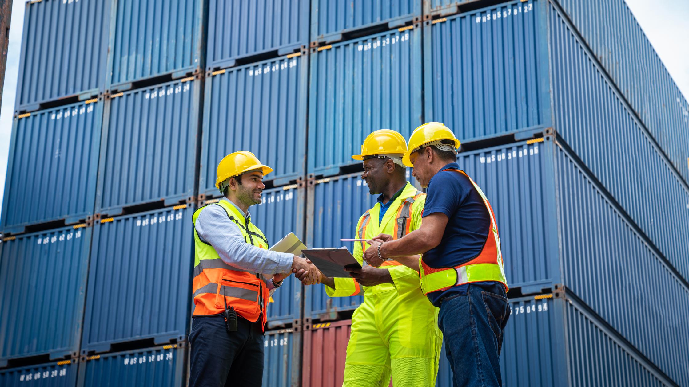 Male Industrial Engineer and Foreman control checking container at container yard warehouse. Logistics business. Import and export concept.